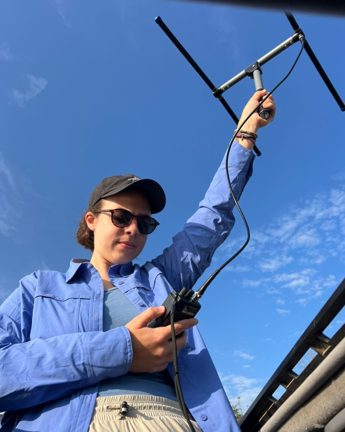 Student holding a GPS antenna